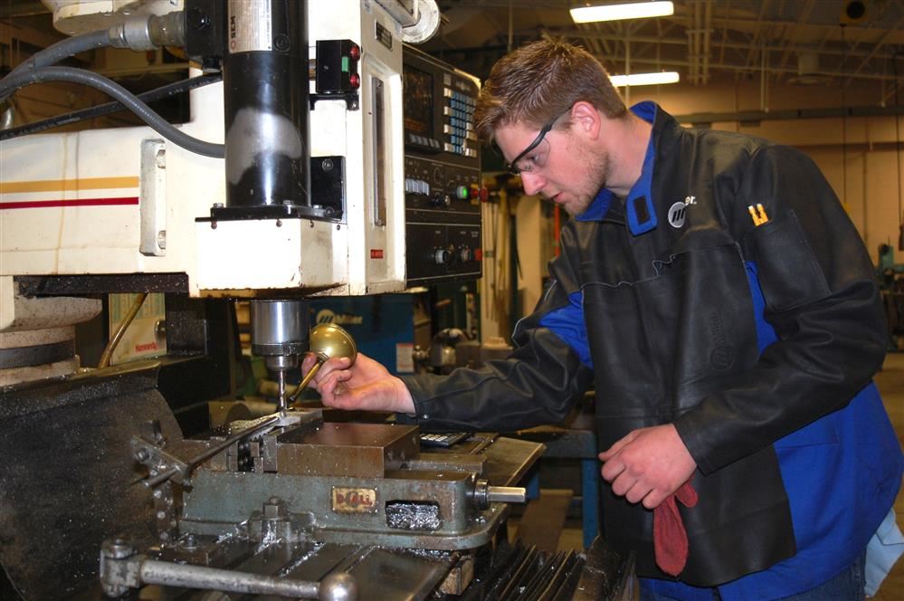 Adult student working on a CNC machine